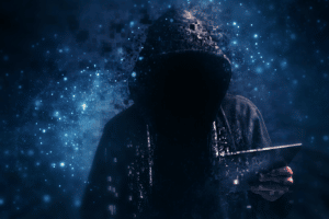 hacker in hoodie holding ipad