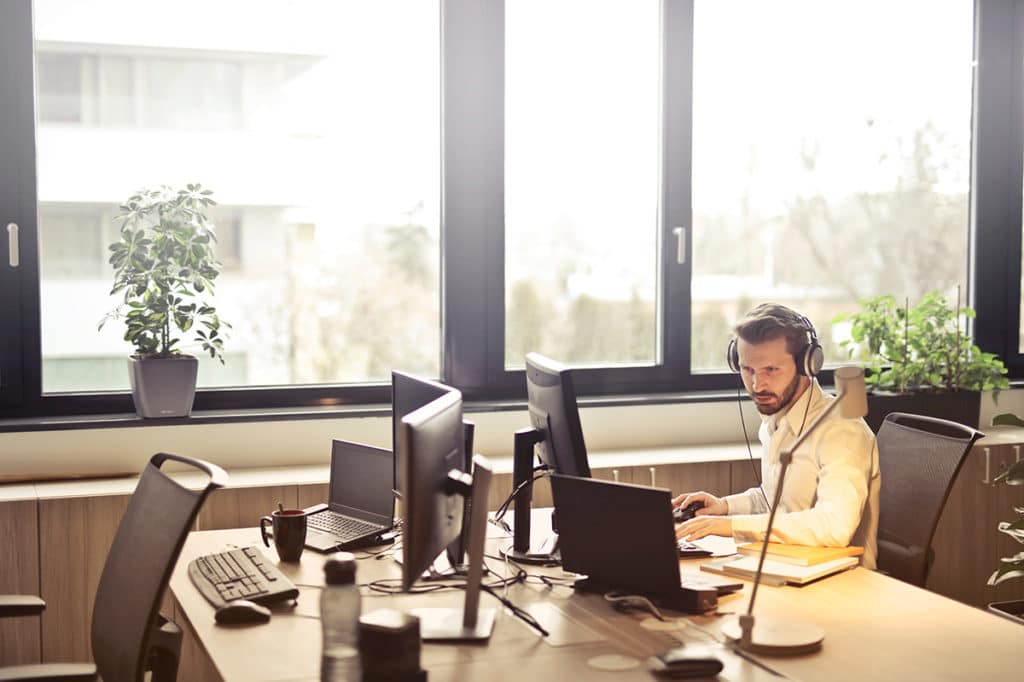 IT provider works on computer in empty office in tri-state area