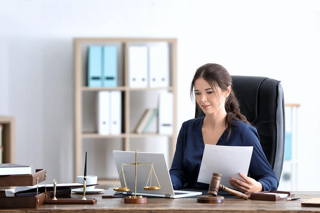 Young female notary working in office of a Stamford IT company