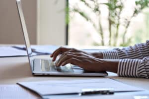 Close up of person typing on laptop