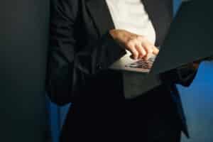 woman in cybersecurity typing on laptop